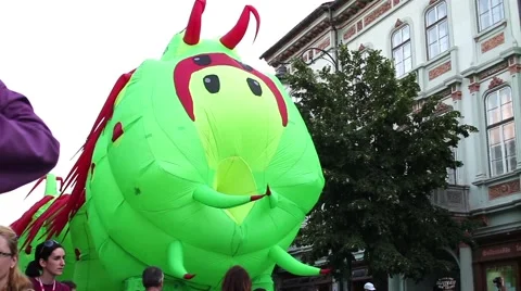 Inflatable caterpillar set in motion by unknown people walking on the main  Stock Footage 60055496