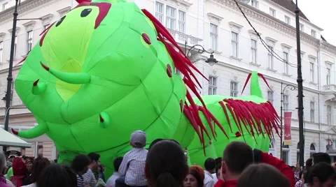 Inflatable caterpillar set in motion by unknown people walking on the main Stock Footage 60055498