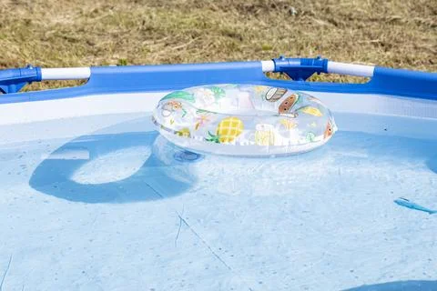 An inflatable circle floats on the water in the pool Stock Photos