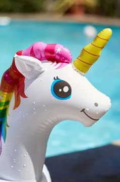 Inflatable circle in the form of a unicorn in the pool Stock Photos