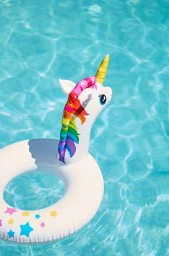 Inflatable circle in the form of a unicorn in the pool Stock Photos
