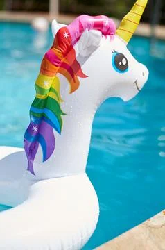 Inflatable circle in the form of a unicorn in the pool Stock Photos