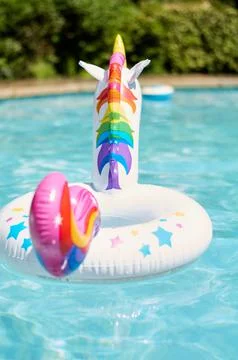 Inflatable circle in the form of a unicorn in the pool Stock Photos