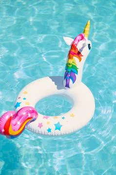 Inflatable circle in the form of a unicorn in the pool Stock Photos