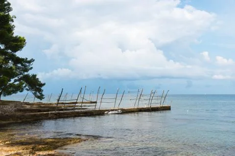 Inflatable dinghy tied to the small dock of Savudrija, Croatia Photos