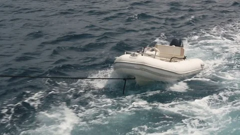Inflatable empty boat tied to the yacht Stock Footage 76738513