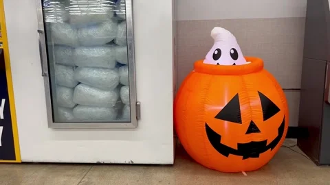 Inflatable Ghost Pop Up from Pumpkin Halloween Decoration Store Display Stock Footage 346489108