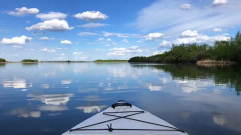 An Inflatable Kayak on a Still and Reflective Lake Stock Footage 195598071
