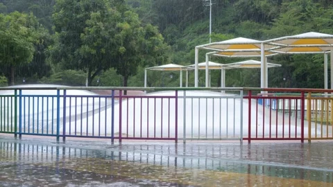 Inflatable kids bouncing playground on rainy day Stock-Footage 347623203