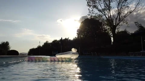 Inflatable mattress floating in the pool Stockbeeldmateriaal 140281840