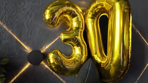 Inflatable numbers 30 against a dark wall Stock Footage 329093719