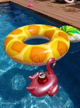Inflatable pineapple ring floating in swimming pool Stock Photos