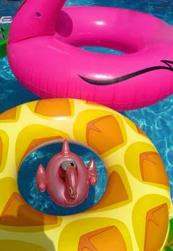 Inflatable pineapple ring floating in swimming pool Stock Photos