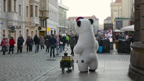 Inflatable polar bear mascot dancing on city street. Stock Footage 332945743