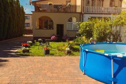 An inflatable pool stands in the yard Stock Photos