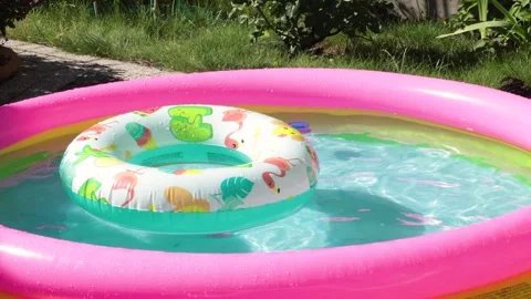 Inflatable pool in summer with swimming lap. Children and water games. Summer Stock Footage 279542594