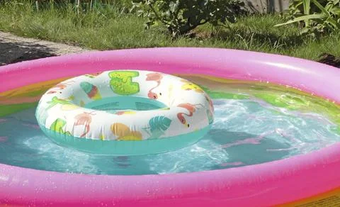 Inflatable pool in summer with swimming lap. Children and water games. Summer Stock Photos