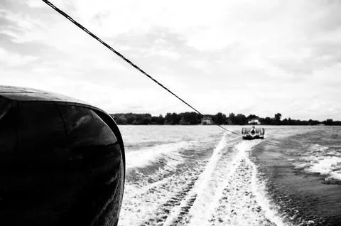 Inflatable raft being pulled at a high speed by a boat in a recreational Stock Photos