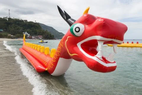 Inflatable red dragon float boat in White beach, Puerto Galera, Philippines Stock Photos