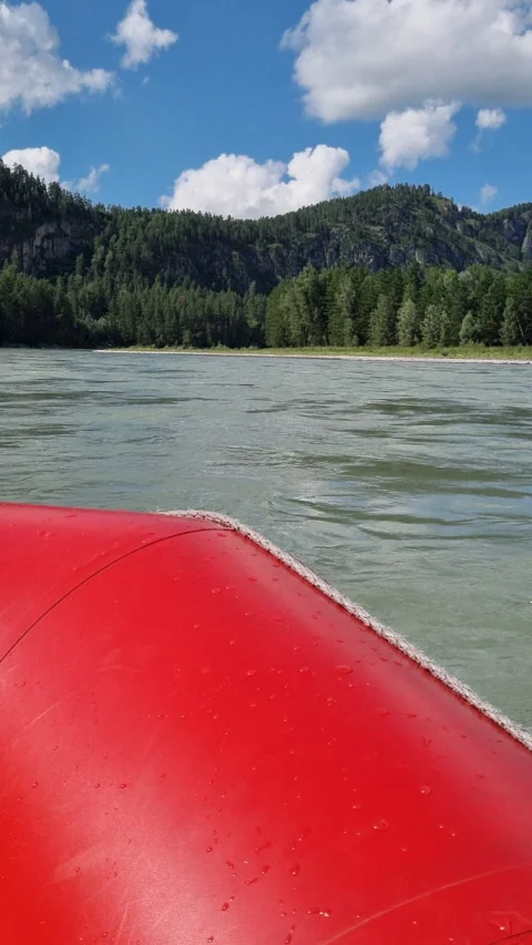 Inflatable red raft drifting through mountain river valley, green forests Stock Footage 315066774