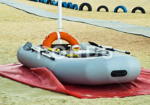 Inflatable Rescue Boat. Gray Inflatable Boat On The Beach In The Sand