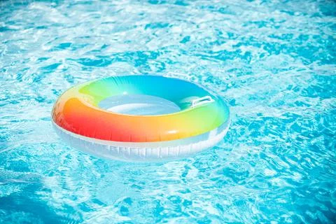 Inflatable ring in blue swimming pool. Colorful inflatable toy in swimming pool 스톡 사진