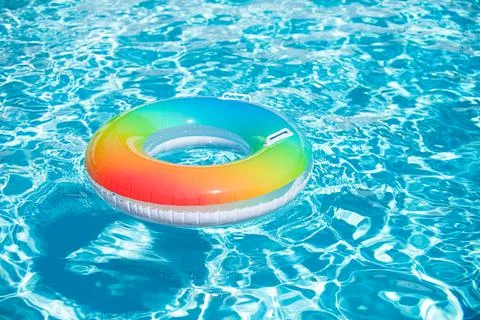 Inflatable ring in blue swimming pool. Summer pool water perfect background. 스톡 사진
