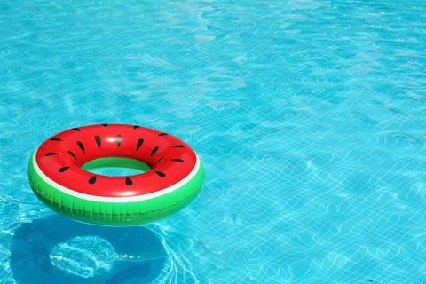 Inflatable ring floating in pool on sunny day Stock Photos