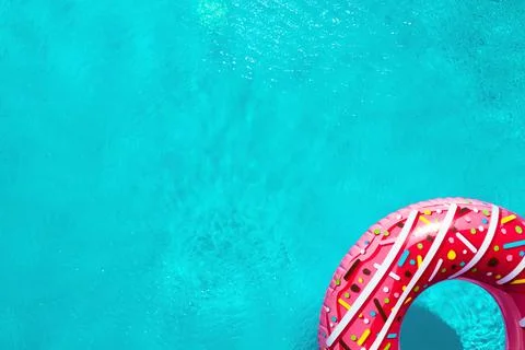 Inflatable ring floating in swimming pool, top view with space for text. Summ Stock Photos
