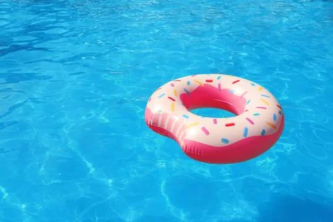 Inflatable ring floating in swimming pool on sunny day. Space for text Stock-Fotos