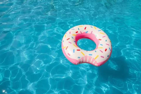 Inflatable ring floating in swimming pool on sunny day. Space for text Stock-Fotos