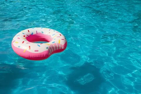 Inflatable ring floating in swimming pool on sunny day. Space for text Stock-Fotos