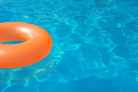 Inflatable ring floating in swimming pool on sunny day. Space for text Stock-Fotos
