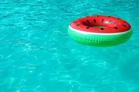 Inflatable ring floating in swimming pool on sunny day. Space for text Stock-Fotos