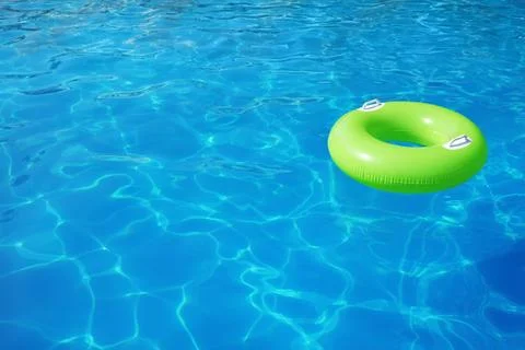 Inflatable ring floating in swimming pool on sunny day. Space for text Stock-Fotos