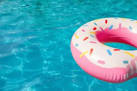 Inflatable ring floating in swimming pool on sunny day. Space for text Stock-Fotos