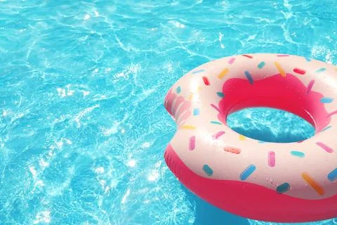 Inflatable ring floating in swimming pool on sunny day. Space for text Stock-Fotos