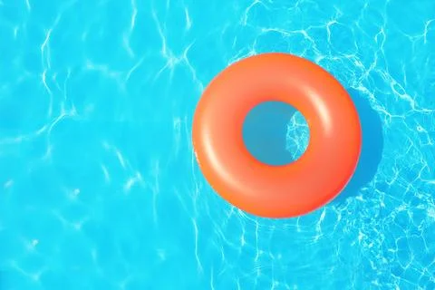 Inflatable ring floating in swimming pool on sunny day, top view with space f Stock Photos