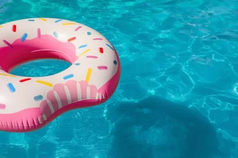 Inflatable ring floating in swimming pool on sunny day. Space for text Stock-Fotos