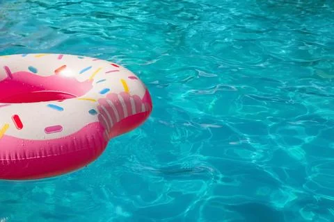 Inflatable ring floating in swimming pool on sunny day. Space for text Stock-Fotos