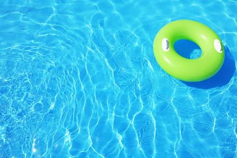 Inflatable ring floating in swimming pool on sunny day. Space for text Stock-Fotos