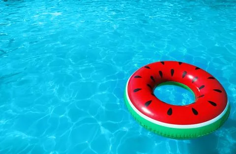 Inflatable ring floating in swimming pool on sunny day. Space for text Stock-Fotos