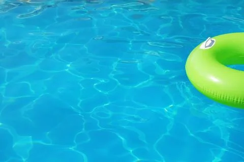 Inflatable ring floating in swimming pool on sunny day. Space for text Stock-Fotos