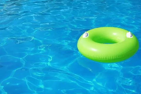 Inflatable ring floating in swimming pool on sunny day. Space for text Stock-Fotos