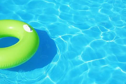 Inflatable ring floating in swimming pool on sunny day. Space for text Stock-Fotos