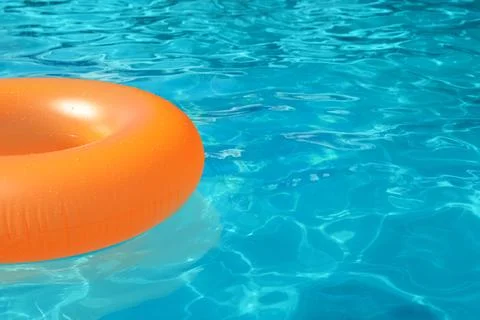 Inflatable ring floating in swimming pool on sunny day. Space for text Stock-Fotos