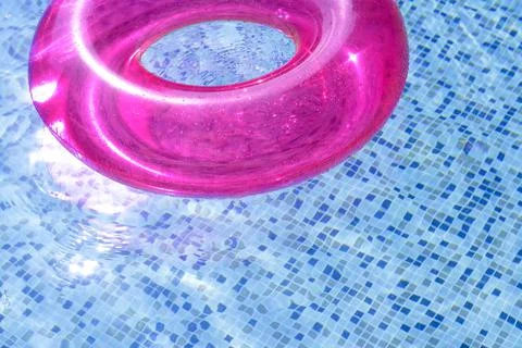 Inflatable ring floating on water in swimming pool Stock Photos