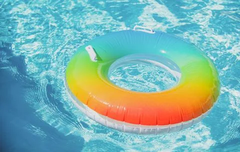 Inflatable rubber ring floating in a blue water in pool. 스톡 사진