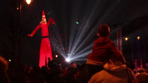 Inflatable Santa Claus, snow, lights and crowd of people, snowing Stock Footage 44643333