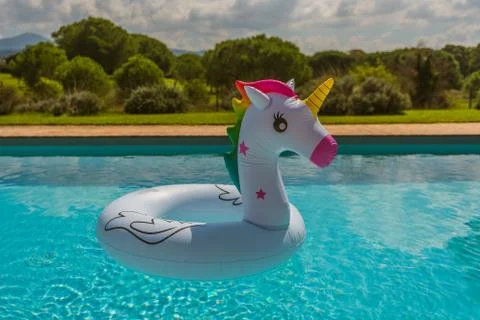 Inflatable in the shape of a unicorn in the pool, summer in Italian country 스톡 사진